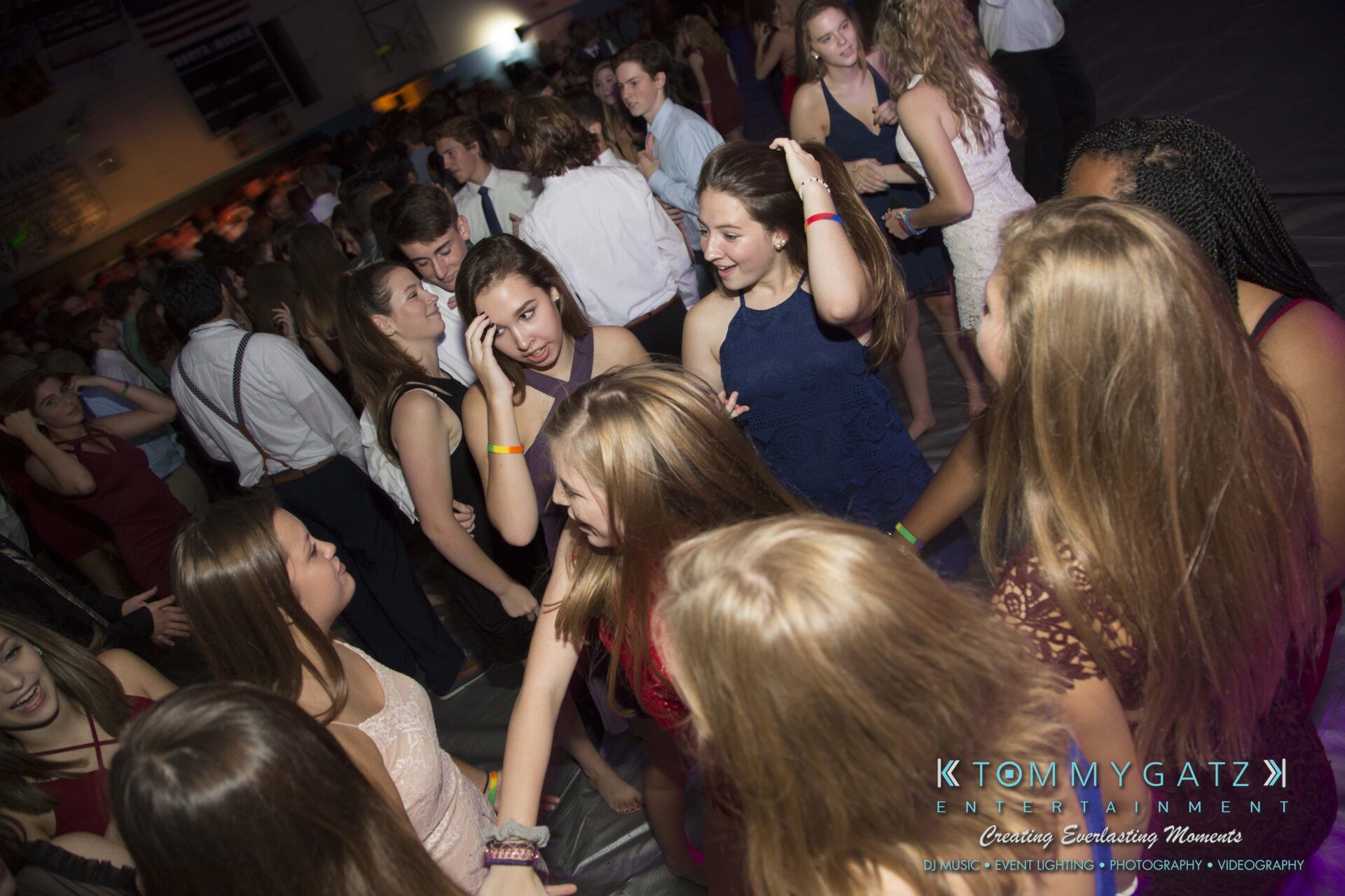 SR-HC-Dance-10717-BLOG-WM-36 - TOMMY GATZ ENTERTAINMENT A group of people in formal attire dancing and socializing in a crowded indoor venue.