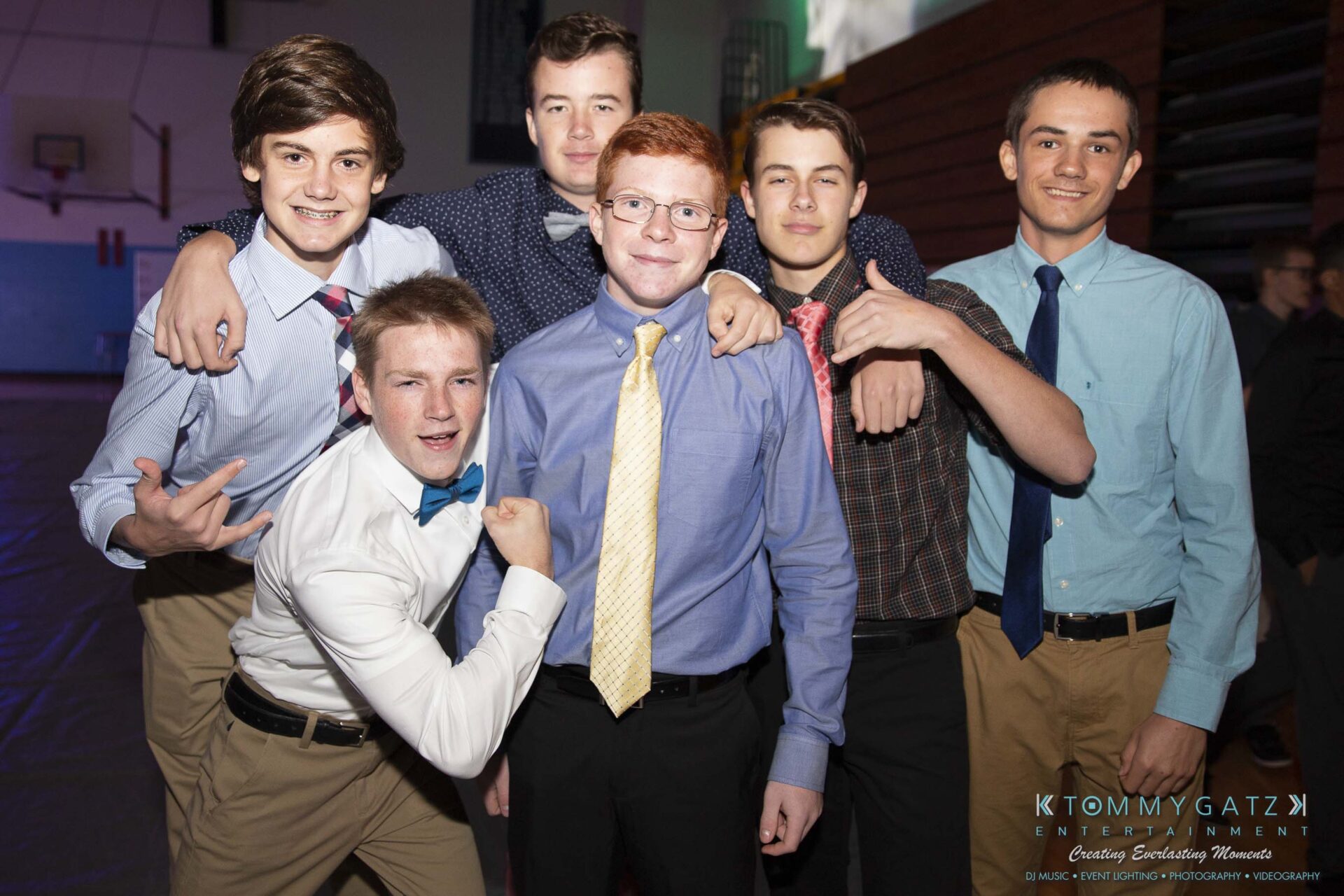 SR-Homecoming-102718-Carl-Low-Res-12 - TOMMY GATZ ENTERTAINMENT A group of six young men in dress shirts and ties pose together in a dimly lit room.