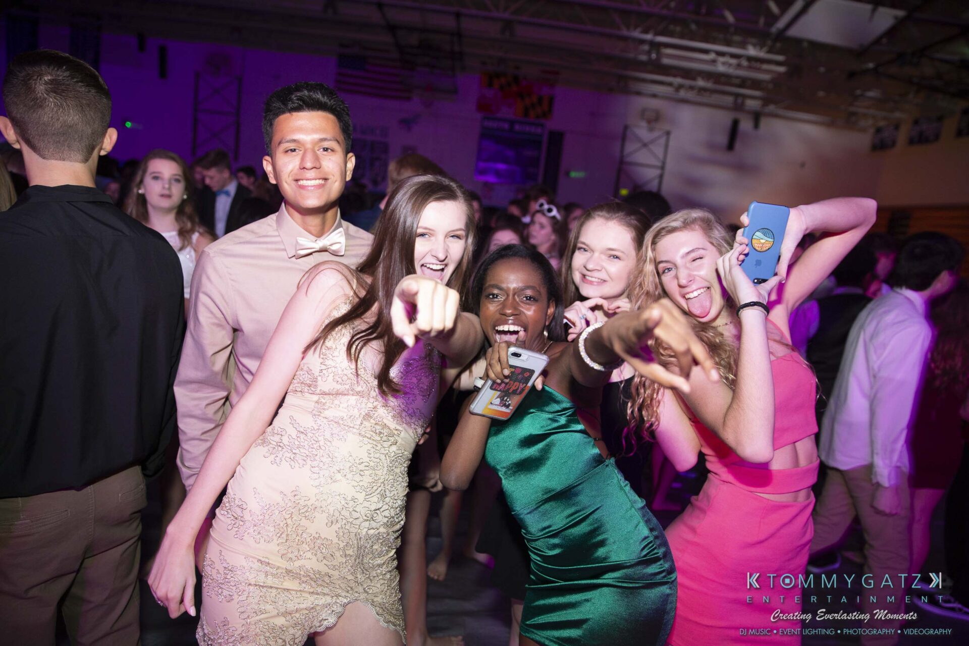 SR-Homecoming-102718-Carl-Low-Res-20 - TOMMY GATZ ENTERTAINMENT A group of five people in formal attire smiling and posing for the camera at a lively indoor event.