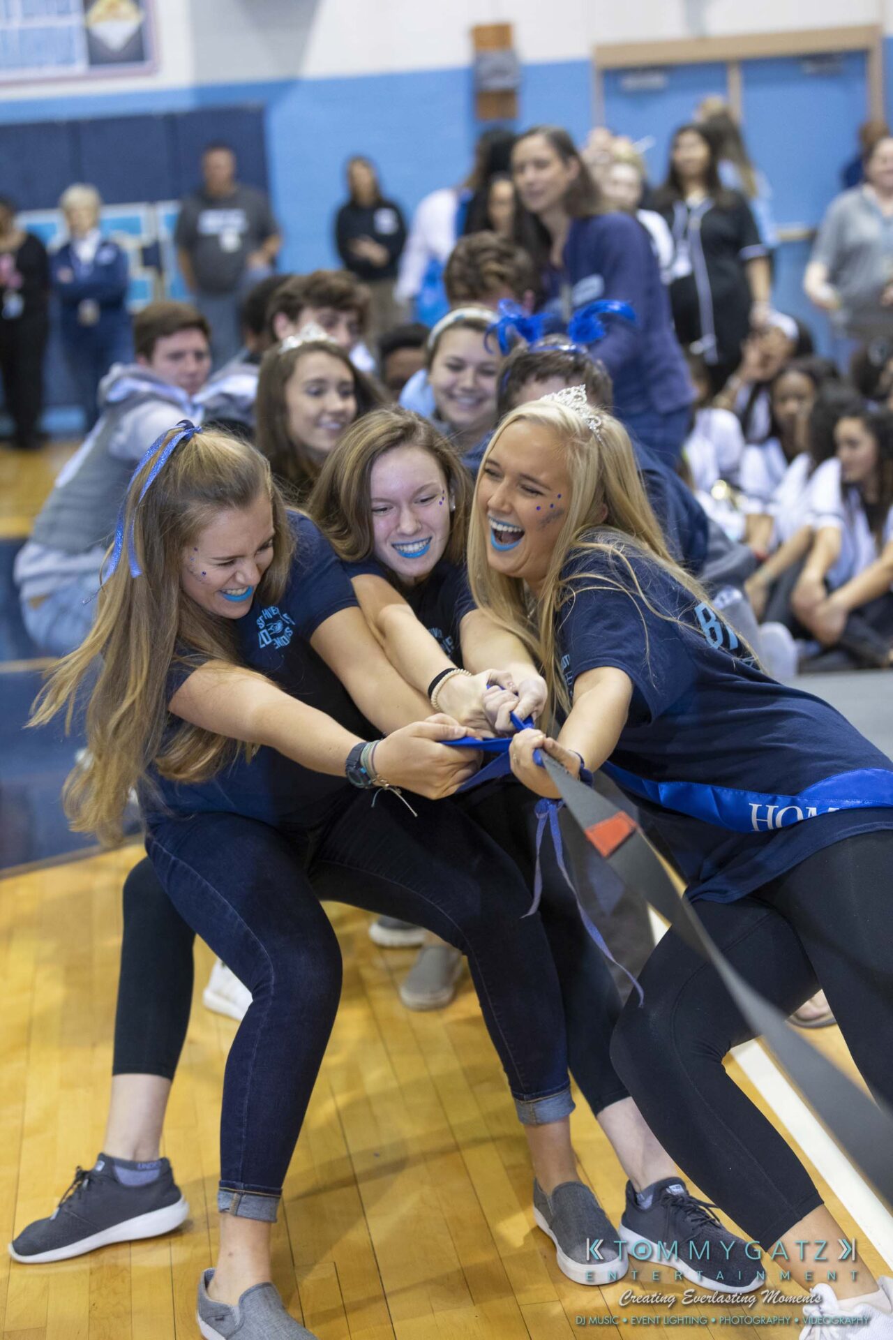 SR-Pep-Rally-102618-Carl-Low-Res-60 - TOMMY GATZ ENTERTAINMENT Group of students enthusiastically participating in a tug-of-war game indoors.