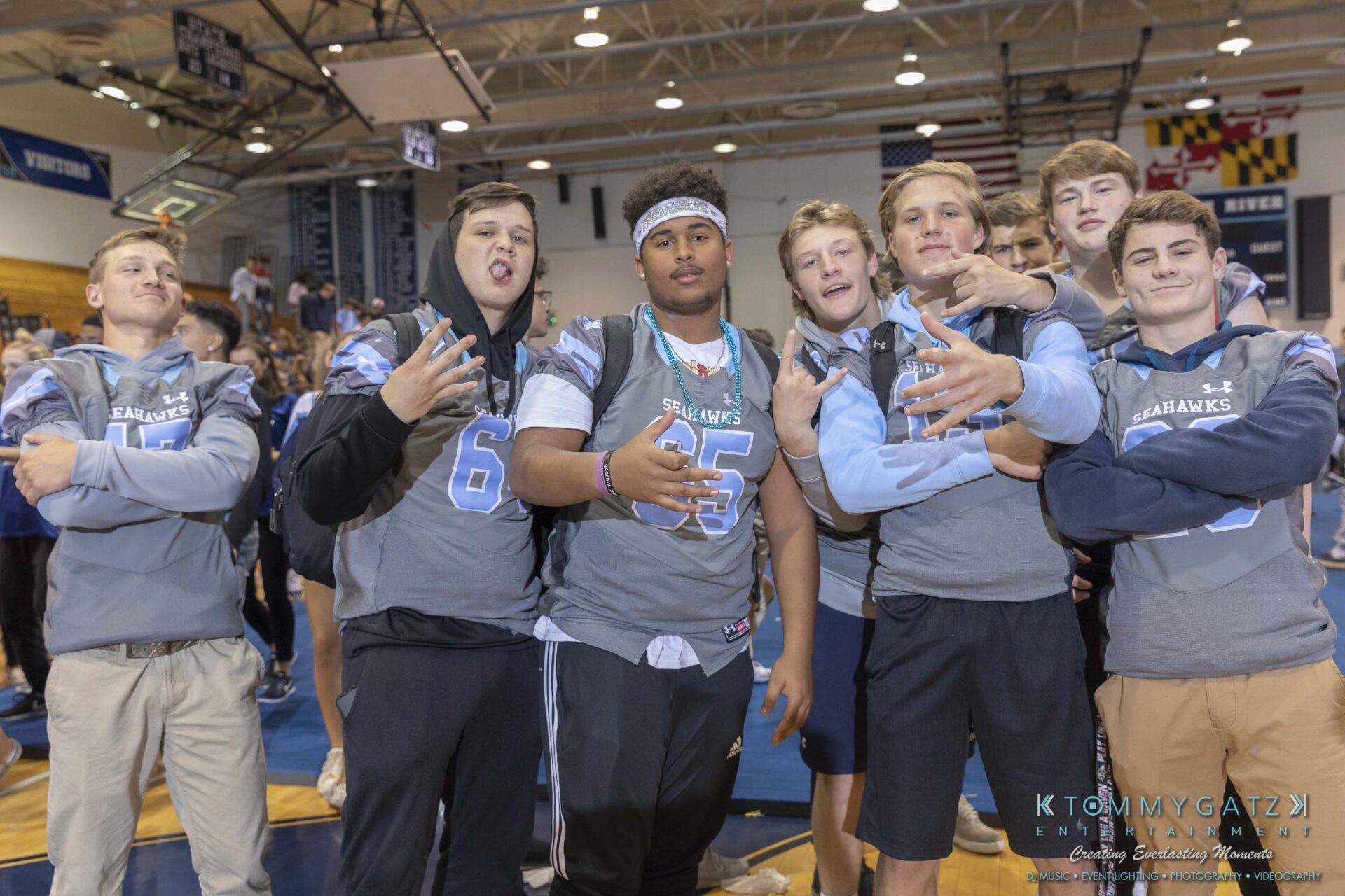 SR-Pep-Rally-102618-Carl-Low-Res-71 - TOMMY GATZ ENTERTAINMENT A group of young men in matching jerseys pose casually inside a gymnasium.