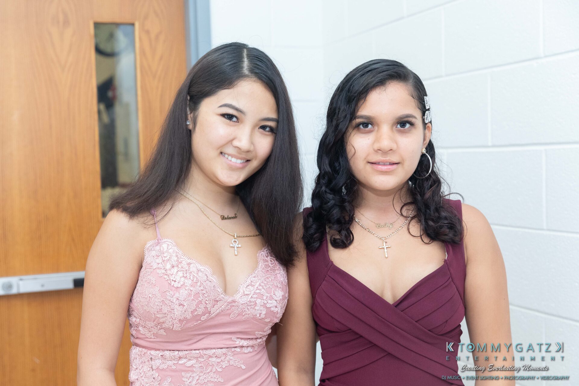 092819-Broadneck-Homecoming-Low-Res-WM-30 - TOMMY GATZ ENTERTAINMENT Two women in evening dresses stand together, smiling in a well-lit indoor setting.