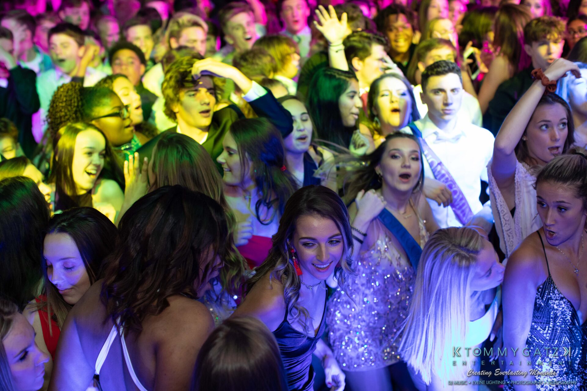 100519-South-River-HC-Dance-Low-Res-WM-31 - TOMMY GATZ ENTERTAINMENT A crowded dance floor with people in formal attire enjoying a lively party under colorful lights.