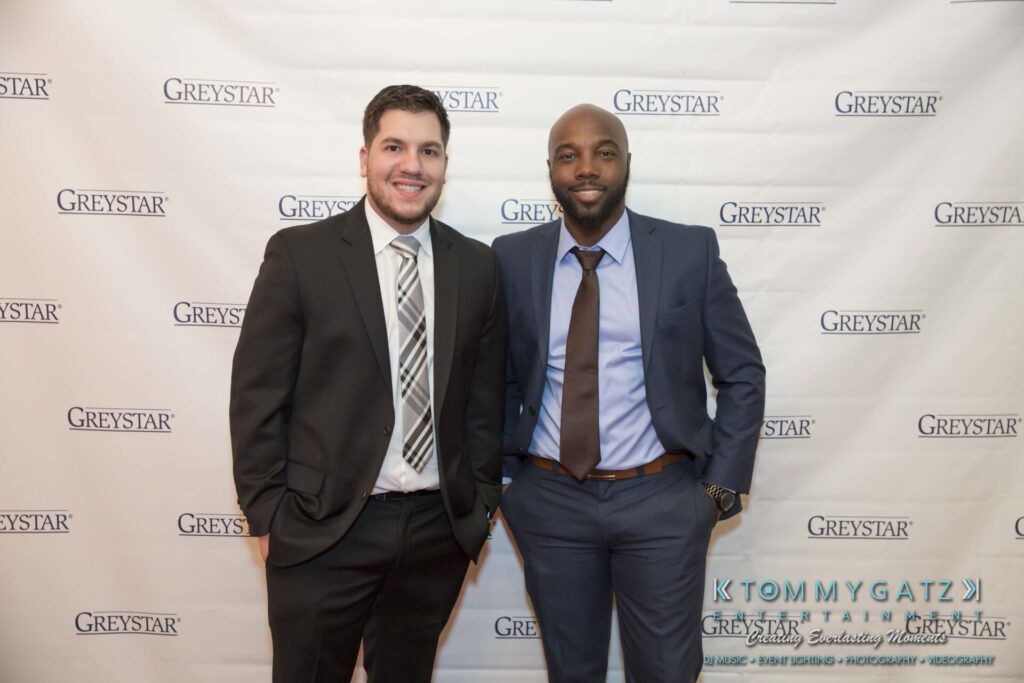 Pillar-Awards-Final-3-24-17-Blog-WM-17 - TOMMY GATZ ENTERTAINMENT Two men in suits standing in front of a Greystar-branded backdrop.