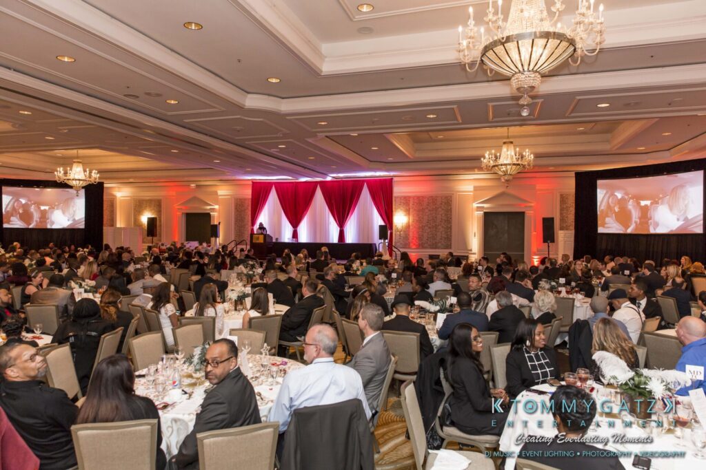 Pillar-Awards-Final-3-24-17-Blog-WM-348 - TOMMY GATZ ENTERTAINMENT A large conference room filled with seated attendees facing a stage with red curtains and large screens.
