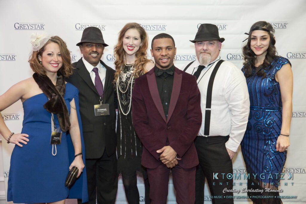 Pillar-Awards-Final-3-24-17-Blog-WM-53 - TOMMY GATZ ENTERTAINMENT Group of six people dressed in formal attire posing in front of a "Greystar" banner.