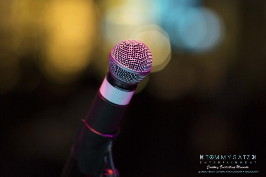 18A0768 - TOMMY GATZ ENTERTAINMENT Close-up of a microphone on a stand with a blurred background.