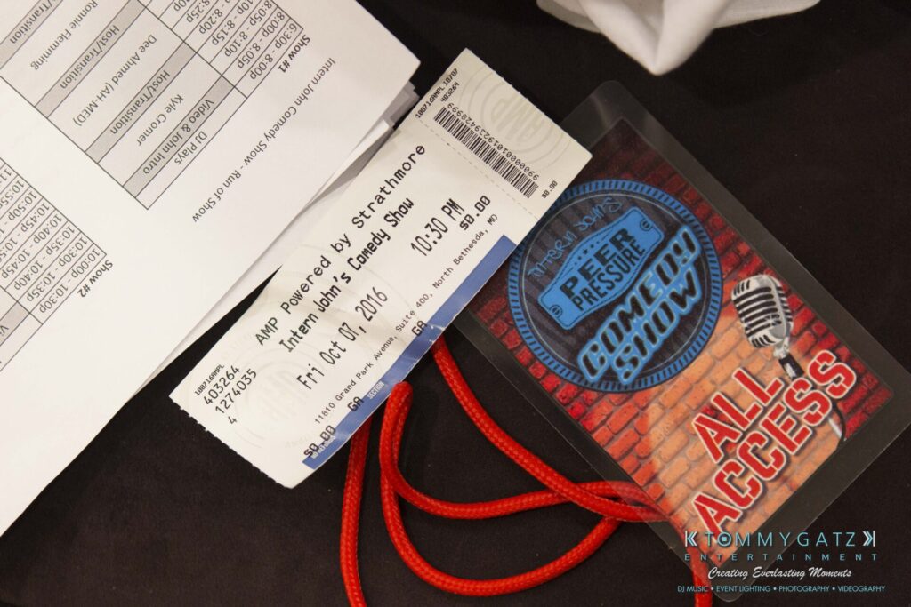 18A0809 - TOMMY GATZ ENTERTAINMENT A ticket and an All Access pass for a comedy show are placed on a paper. The pass has a microphone and "Free of Pressure Comedy Show." The ticket is dated October 21, 2016.