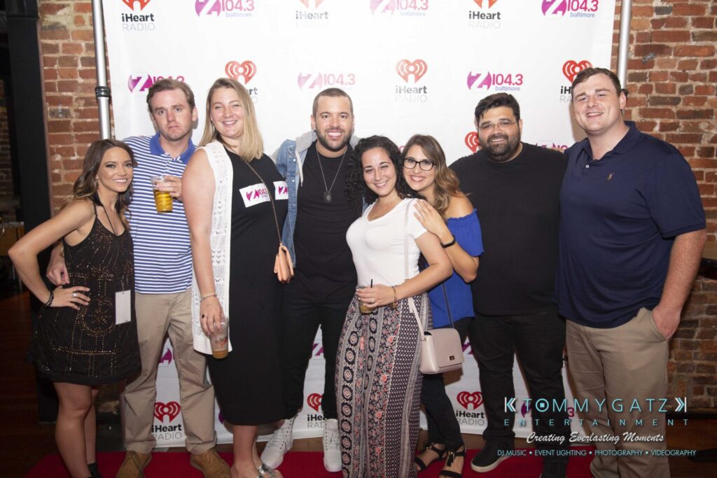 LWYD-Comedy-Tour-Baltimore-060118-FINALS-Low-Res-Watermark-336 - TOMMY GATZ ENTERTAINMENT Group of people posing in front of a iHeartRadio and Z104.3 backdrop.