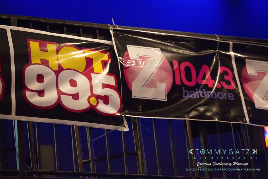 LWYD-Comedy-Tour-Baltimore-060118-FINALS-Low-Res-Watermark-4 - TOMMY GATZ ENTERTAINMENT Banners for HOT 99.5 and Z 104.3 Baltimore are displayed on a railing.