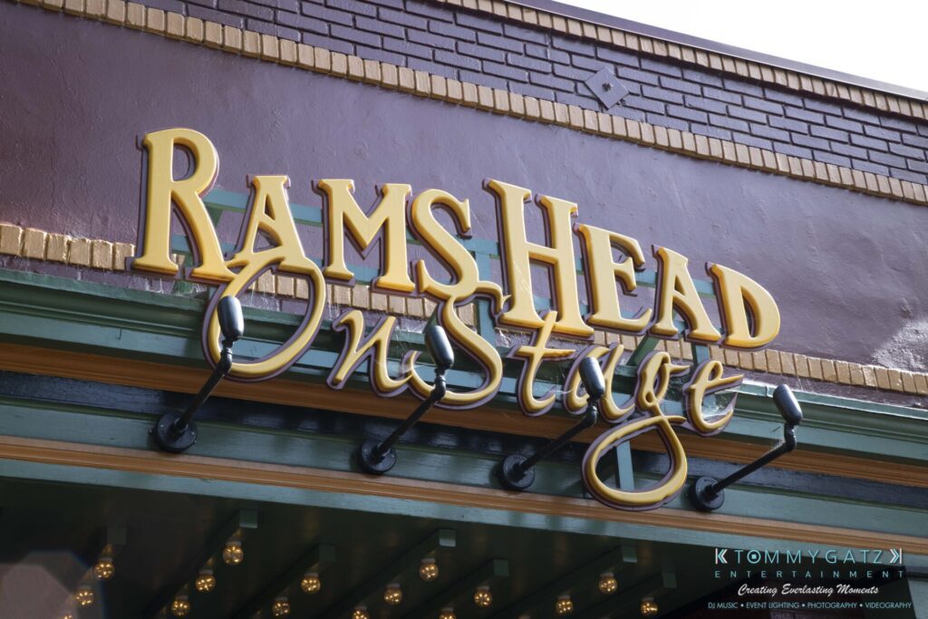 061519-Annapolis-RAMSHEAD-Low-Res-WM-14 - TOMMY GATZ ENTERTAINMENT Sign for "Rams Head On Stage" with decorative gold letters against a purple and green background.