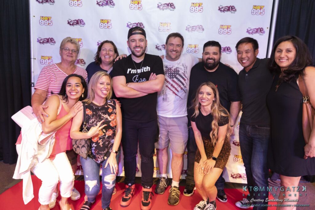 061519-Annapolis-RAMSHEAD-Low-Res-WM-226 - TOMMY GATZ ENTERTAINMENT A group of people posing together on a red carpet in front of a backdrop with logos.
