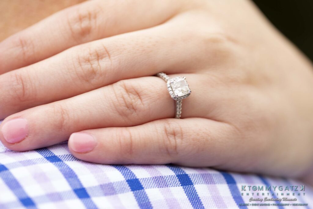 Jon-Christine-111218-Blog-Low-Res-2 - TOMMY GATZ ENTERTAINMENT A hand with a diamond ring rests on a plaid fabric surface.