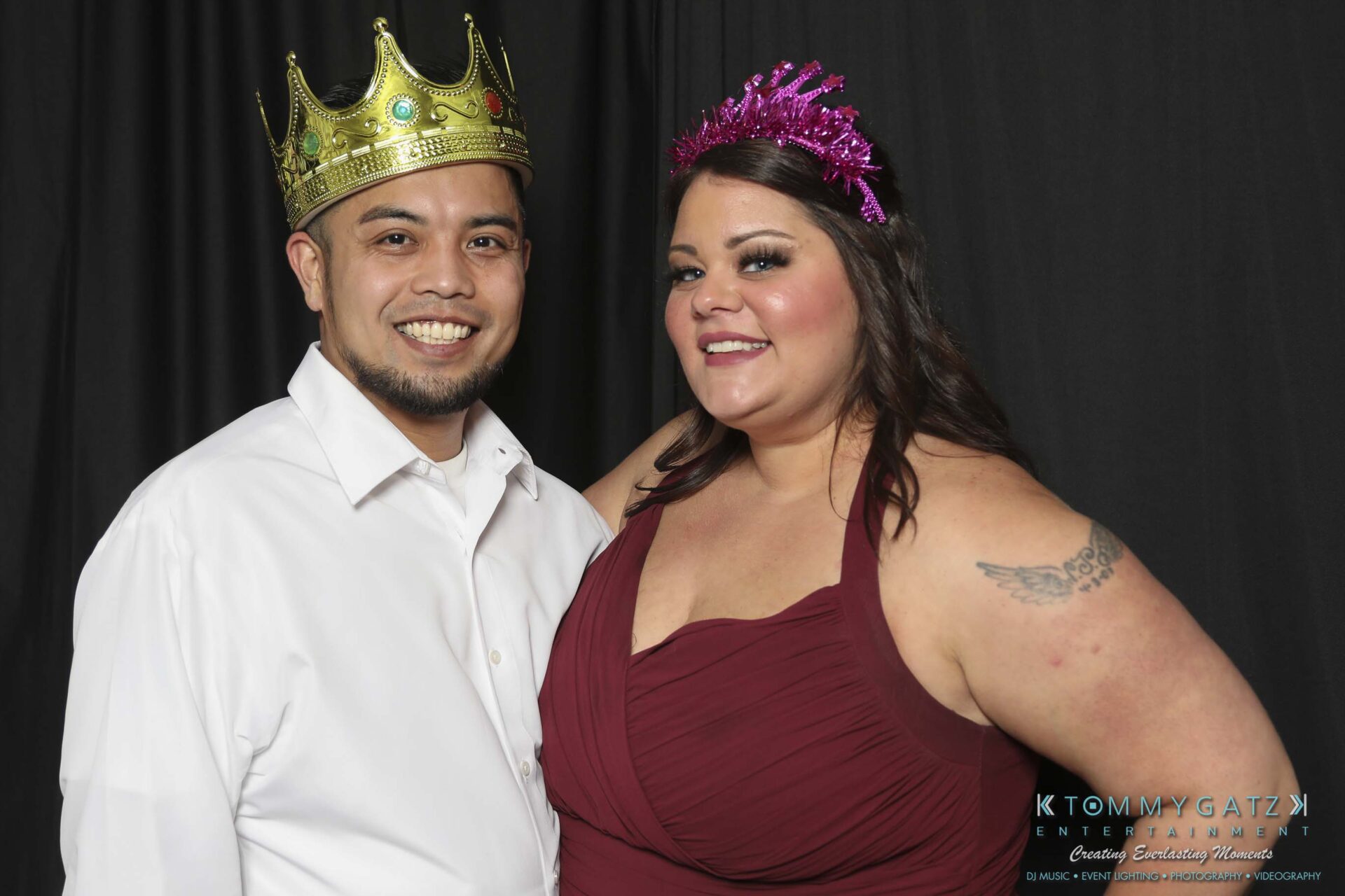 Megan-Matt-102718-Blow-WM-22 - TOMMY GATZ ENTERTAINMENT A man in a gold crown and a woman in a purple crown smile together. She is wearing a red dress and he is in a white shirt.