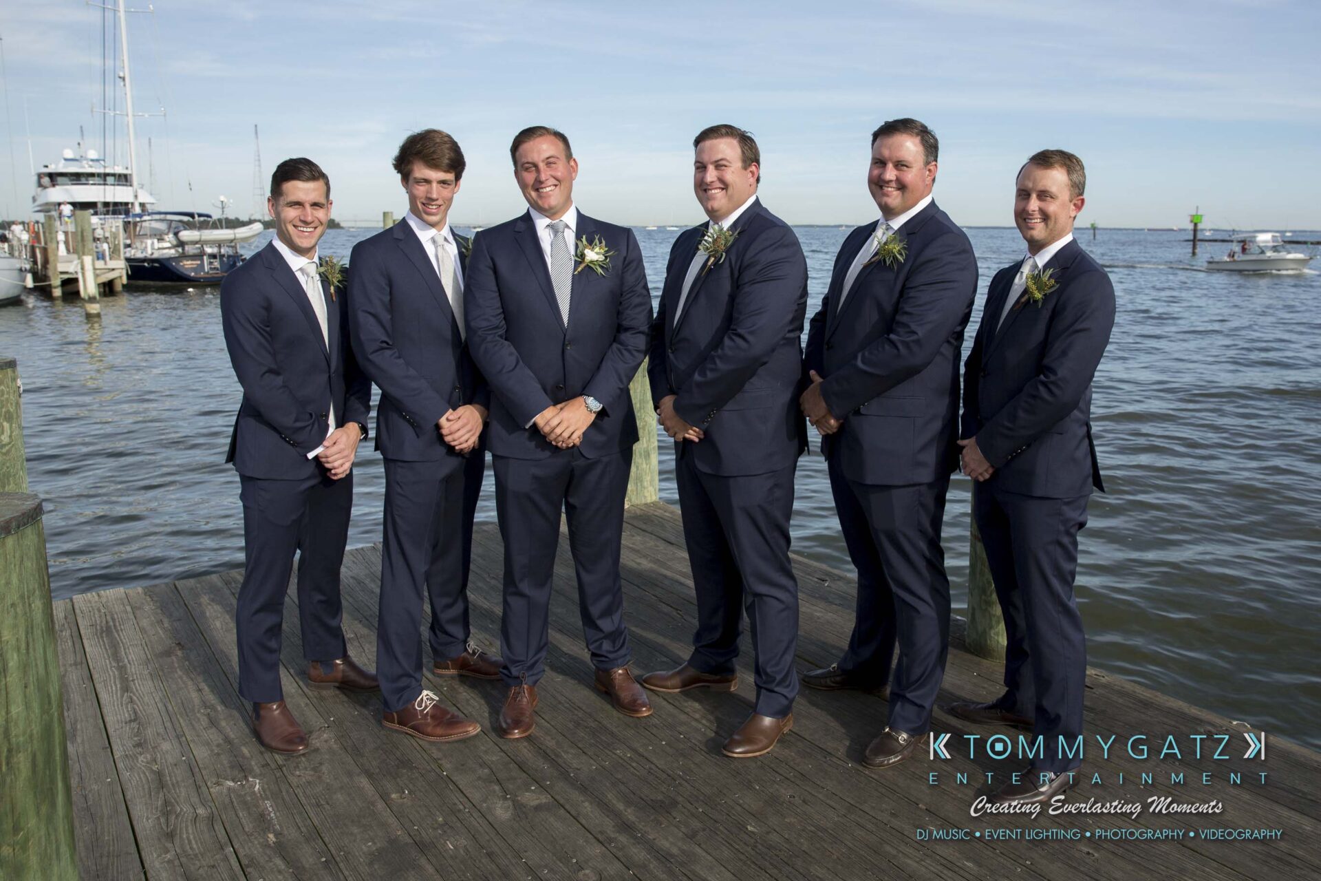 Amanda-Tyler-102117-PREP-Low-Res-WM-162 - TOMMY GATZ ENTERTAINMENT Six men in suits stand on a dock by the water, posing for a group photo.