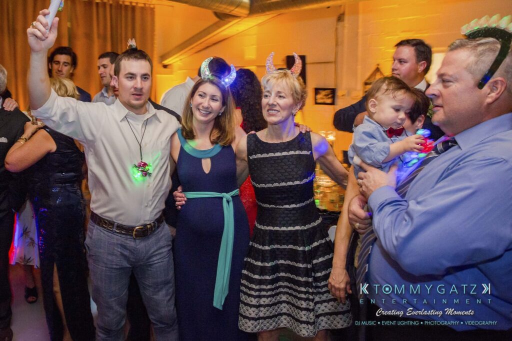 Amanda-Tyler-102117-RECEPTION-Low-Res-WM-185 - TOMMY GATZ ENTERTAINMENT A group of people at a party, some wearing headbands and one holding a child.