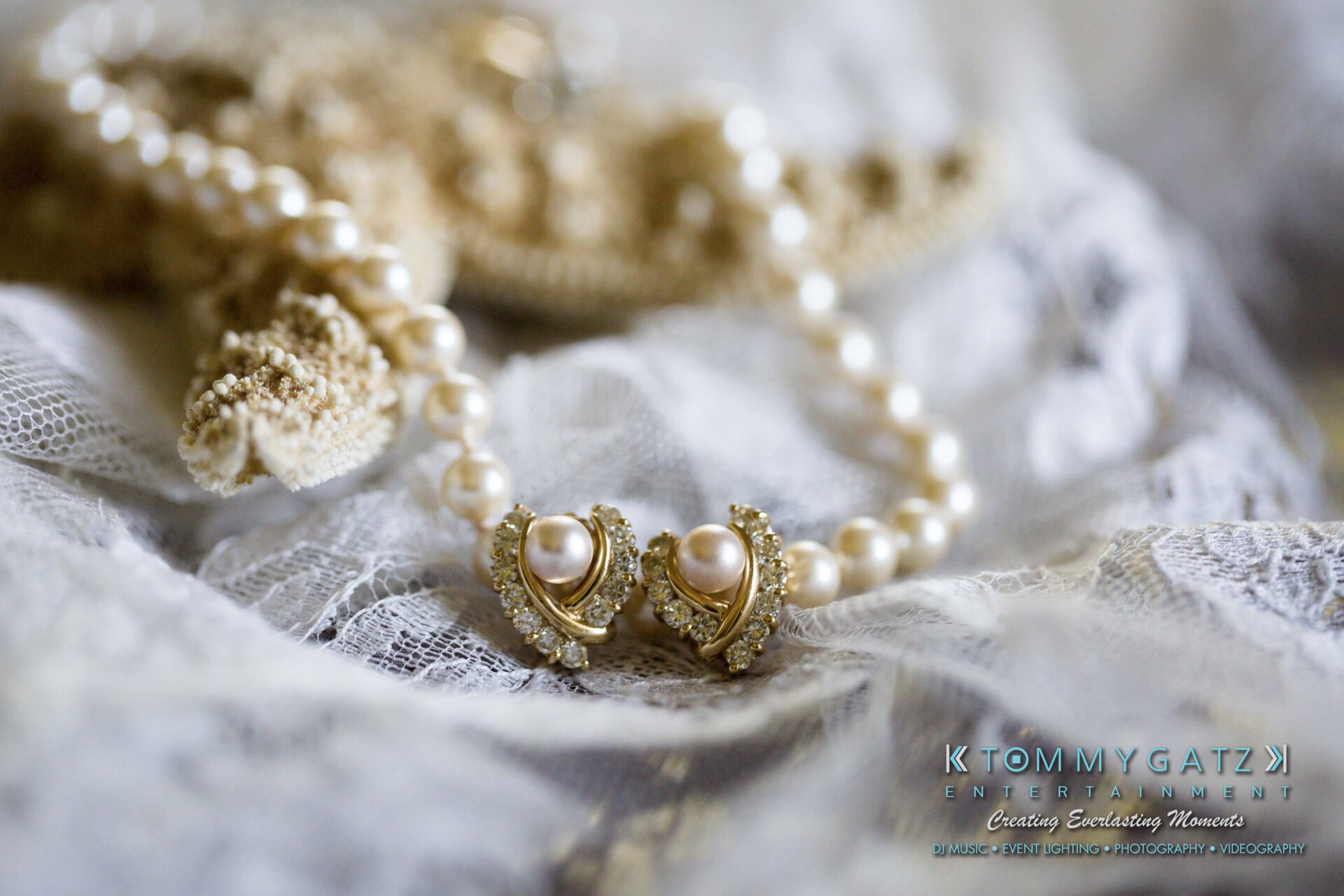 Ann-Marie-Alex-92317-PREP-Low-Res-WM-119 - TOMMY GATZ ENTERTAINMENT A pearl necklace with ornate gold settings on lace fabric.