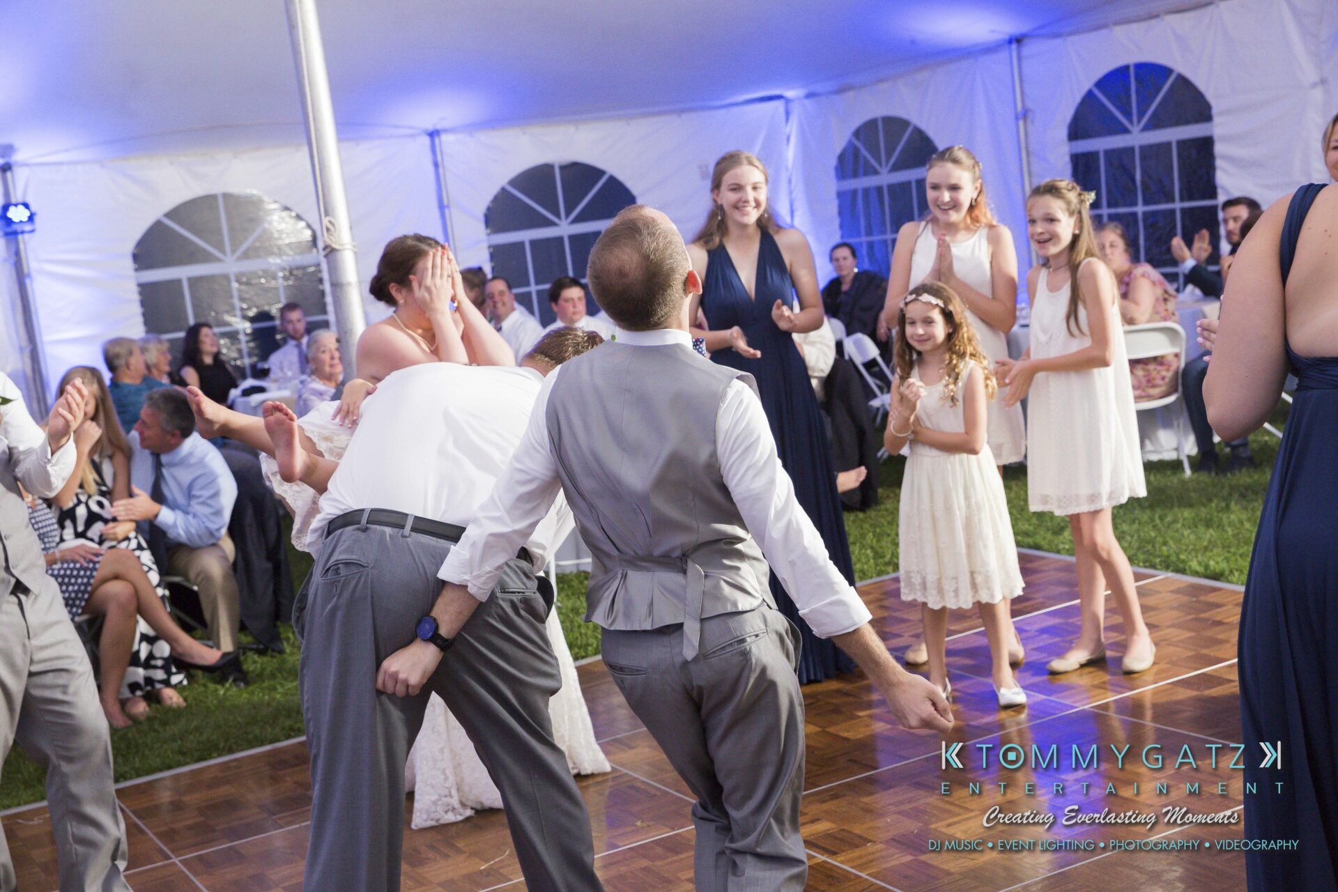 Ann-Marie-Alex-92317-RECEPTION-Low-Res-WM-80 - TOMMY GATZ ENTERTAINMENT A group of people in formal attire dance and laugh under a tent during an event.