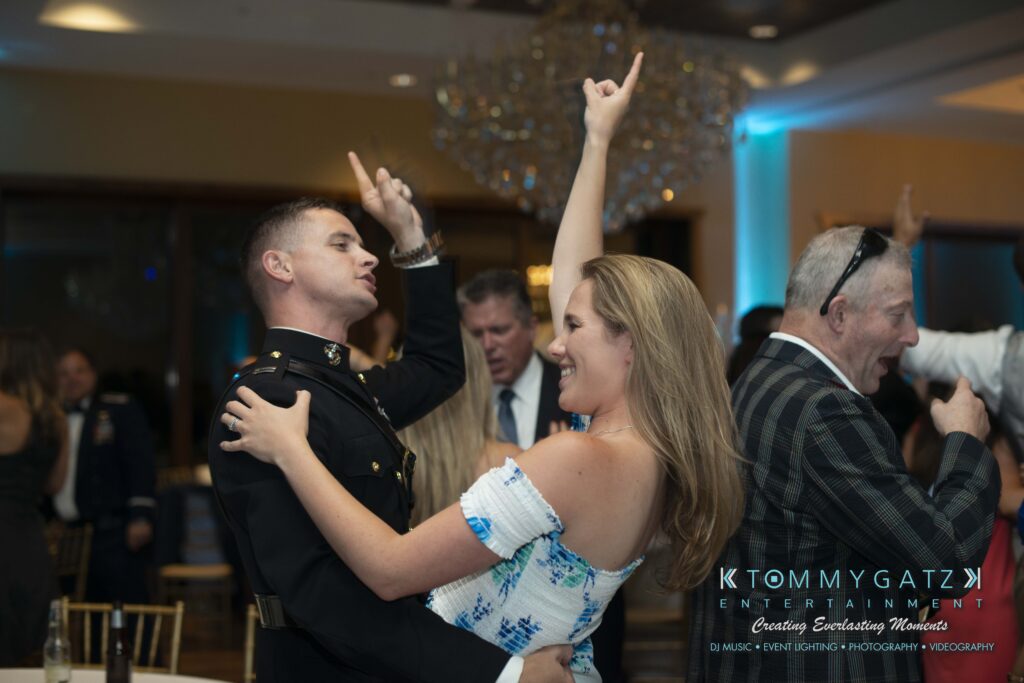 Annie-Casey-060918-RECEPTION-Low-Res-WM-1041 - TOMMY GATZ ENTERTAINMENT People dancing joyfully at a formal event, with a DJ logo in the corner.