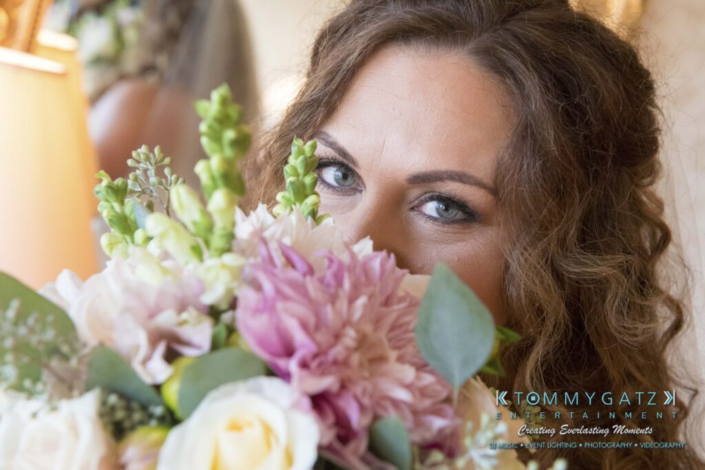 Elizabeth-Tom-101417-PREP-Low-Res-WM-28 - TOMMY GATZ ENTERTAINMENT Person holding a bouquet of pink and white flowers, partially covering their face.