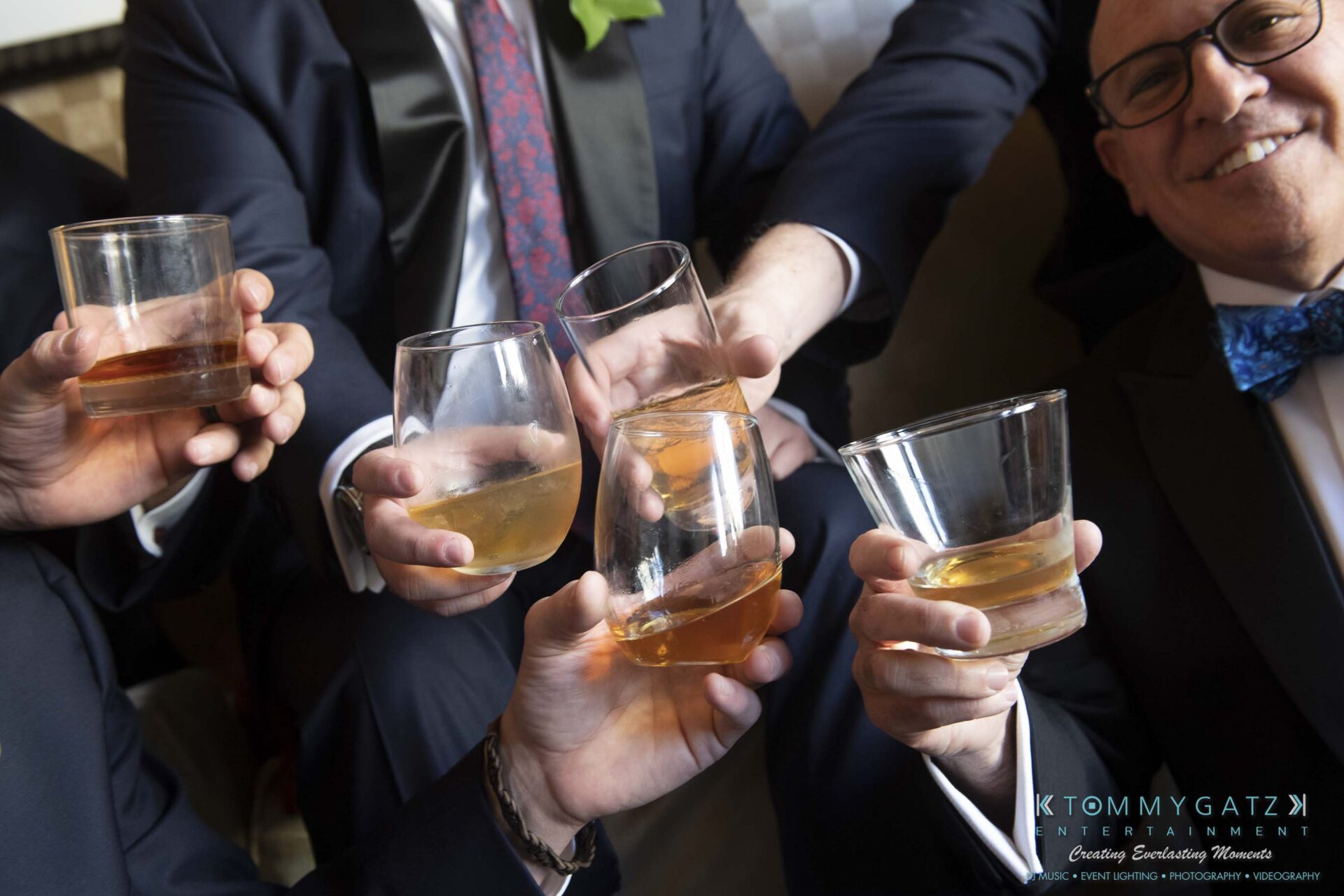 A group of people in formal attire raising glasses in a toast.