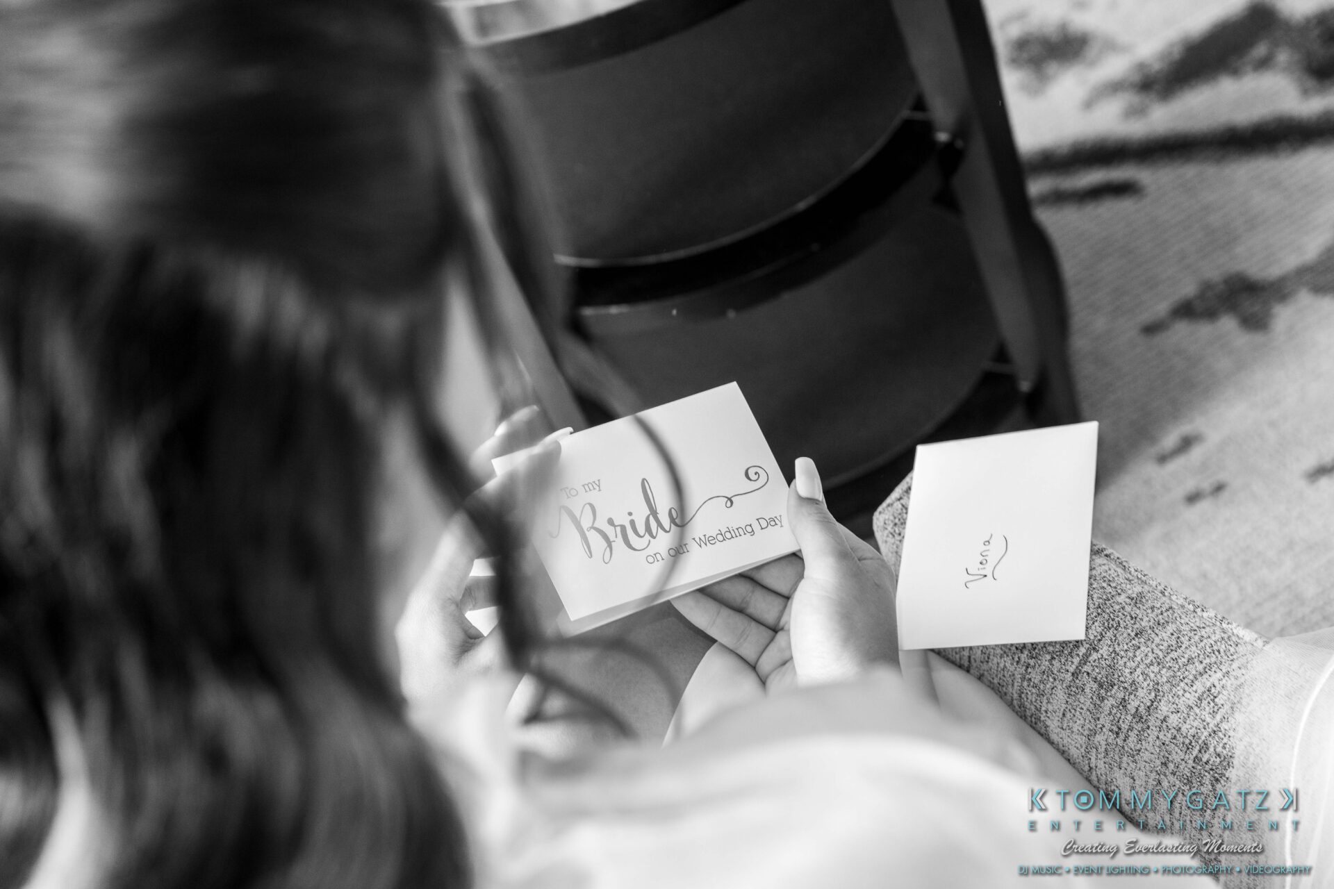 Harris-Wedding-HIGHLIGHTS-090119-17 - TOMMY GATZ ENTERTAINMENT A woman holds an envelope labeled "To The Bride on Our Wedding Day" next to a smaller envelope labeled "Tyler" on a chair.