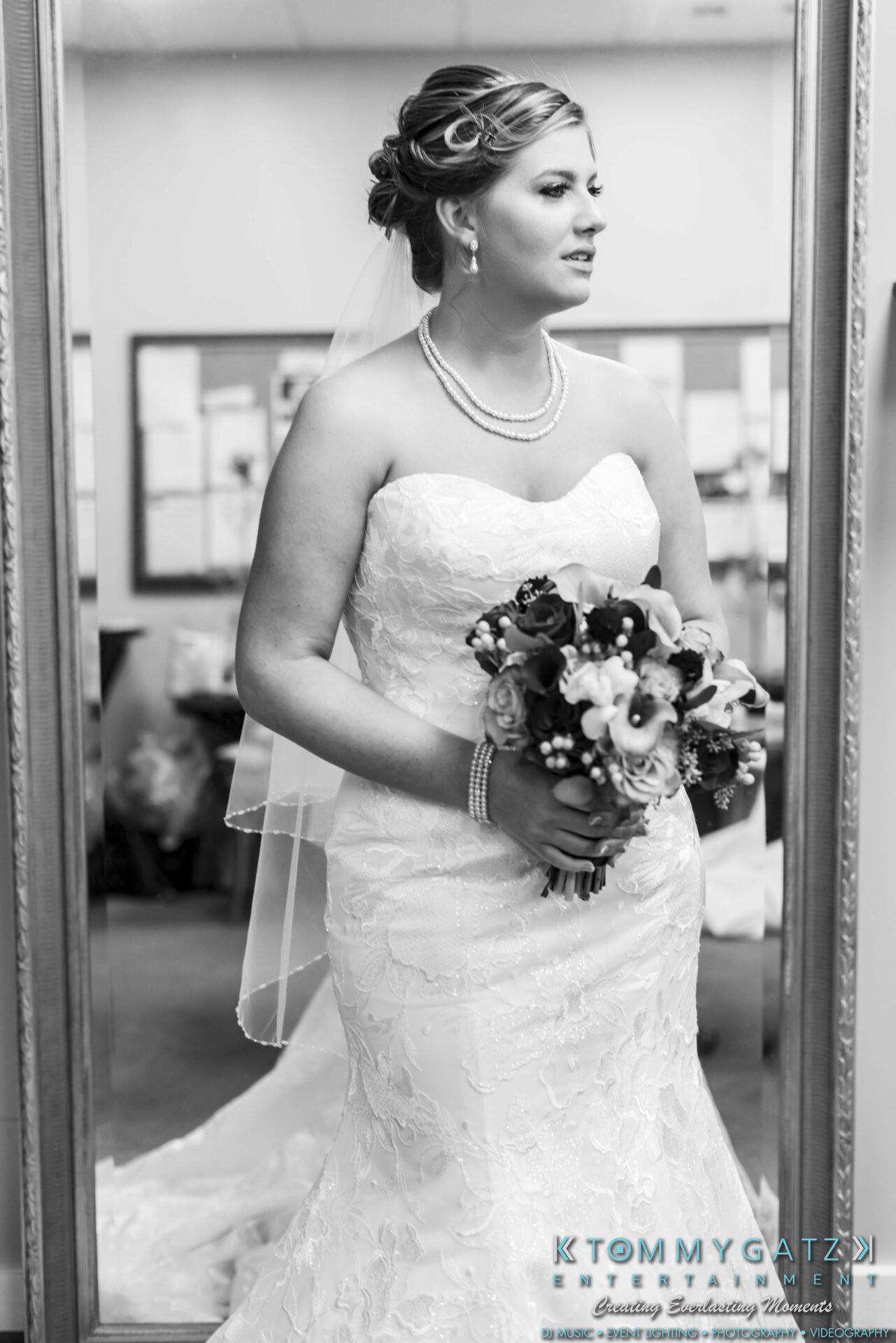 Lisa-Robert-092218-BLOG-selections-WM-10 - TOMMY GATZ ENTERTAINMENT Bride in strapless lace gown holding a bouquet, standing in front of a mirror.