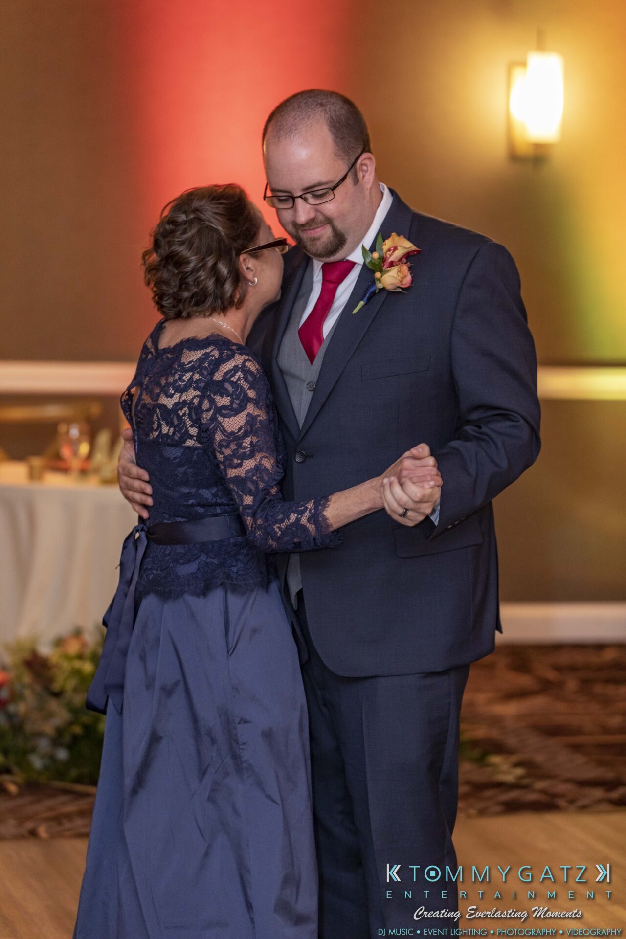 Lisa-Robert-092218-BLOG-selections-WM-92 - TOMMY GATZ ENTERTAINMENT A man and woman, dressed formally, share a close dance in a warmly lit room.