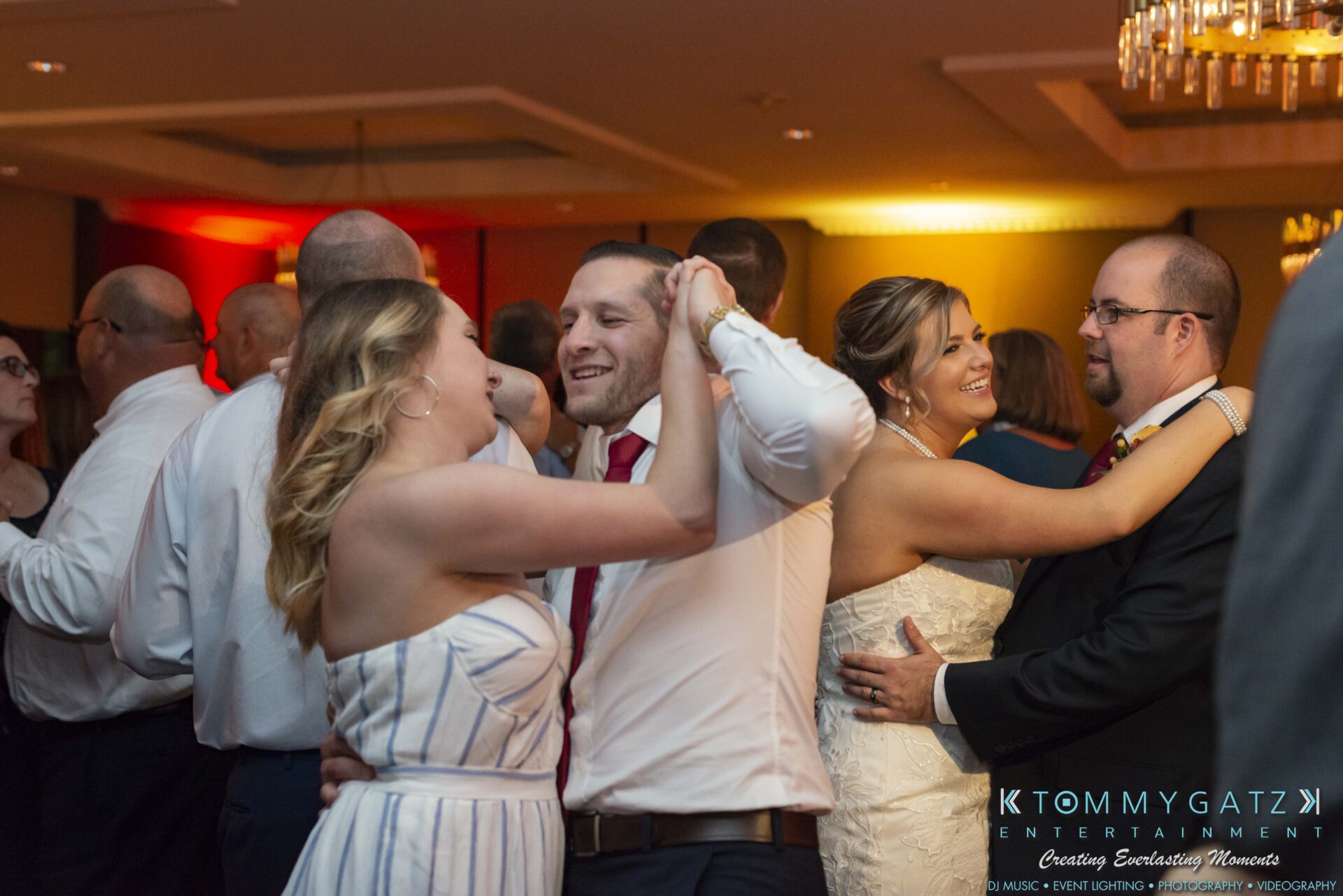 Lisa-Robert-092218-BLOG-selections-WM-97 - TOMMY GATZ ENTERTAINMENT People dancing in pairs at an indoor social gathering. The room is warmly lit, and everyone appears to be enjoying the event.