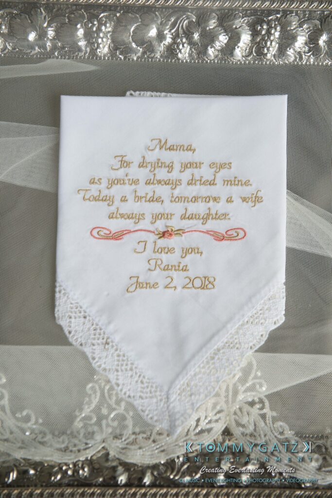 Urania-Aristidis-060218-PREP-Low-Res-WM-26 - TOMMY GATZ ENTERTAINMENT A handkerchief with embroidered text for a mother, expressing love from a daughter, dated June 2, 2018.