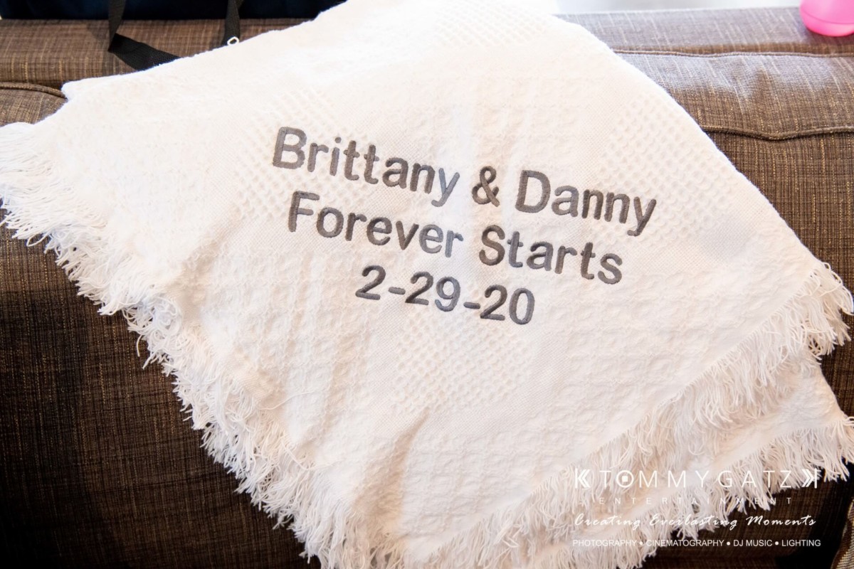 BrittanyDaniel-WEDDING-Highlights-4 - TOMMY GATZ ENTERTAINMENT White blanket with the text "Brittany & Danny Forever Starts 2-29-20" embroidered in black.