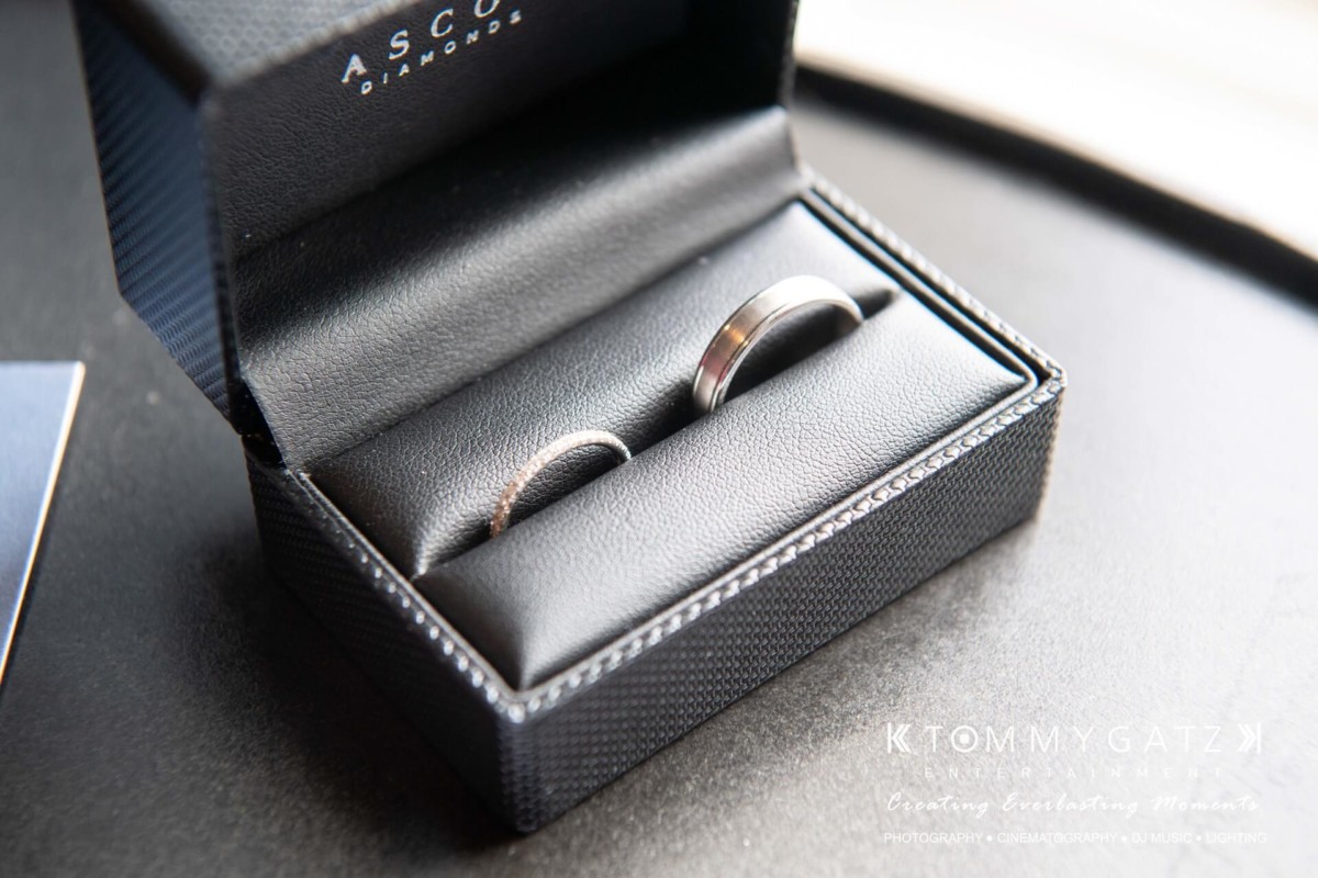 BrittanyDaniel-WEDDING-Highlights-9 - TOMMY GATZ ENTERTAINMENT Two silver rings in a black, open jewelry box.