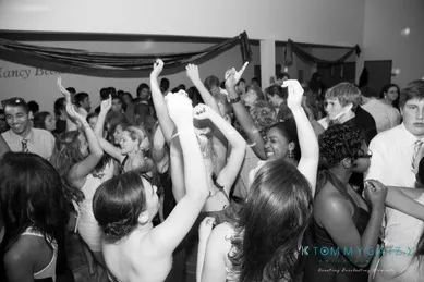 A large group of people dancing and celebrating at a party.