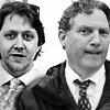 Two men in suits and ties, looking at the camera, black and white image.