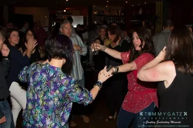 People dancing and socializing in a lively indoor party setting.