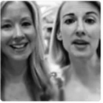 Two women are shown in a black-and-white photograph. Both have long hair and are facing the camera.