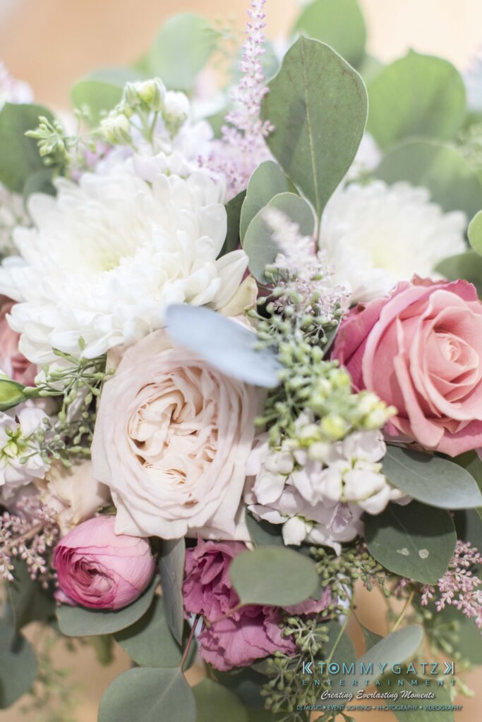 JenniferRudiWeddingPrepPhotos-41-1 - TOMMY GATZ ENTERTAINMENT A close-up of a bouquet featuring roses, chrysanthemums, and assorted greenery.