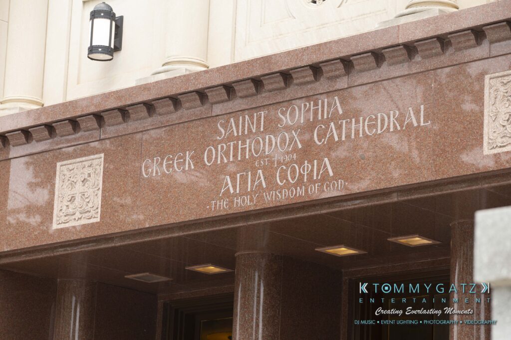 Sign for Saint Sophia Greek Orthodox Cathedral with engraved text detailing its name and establishment year.
