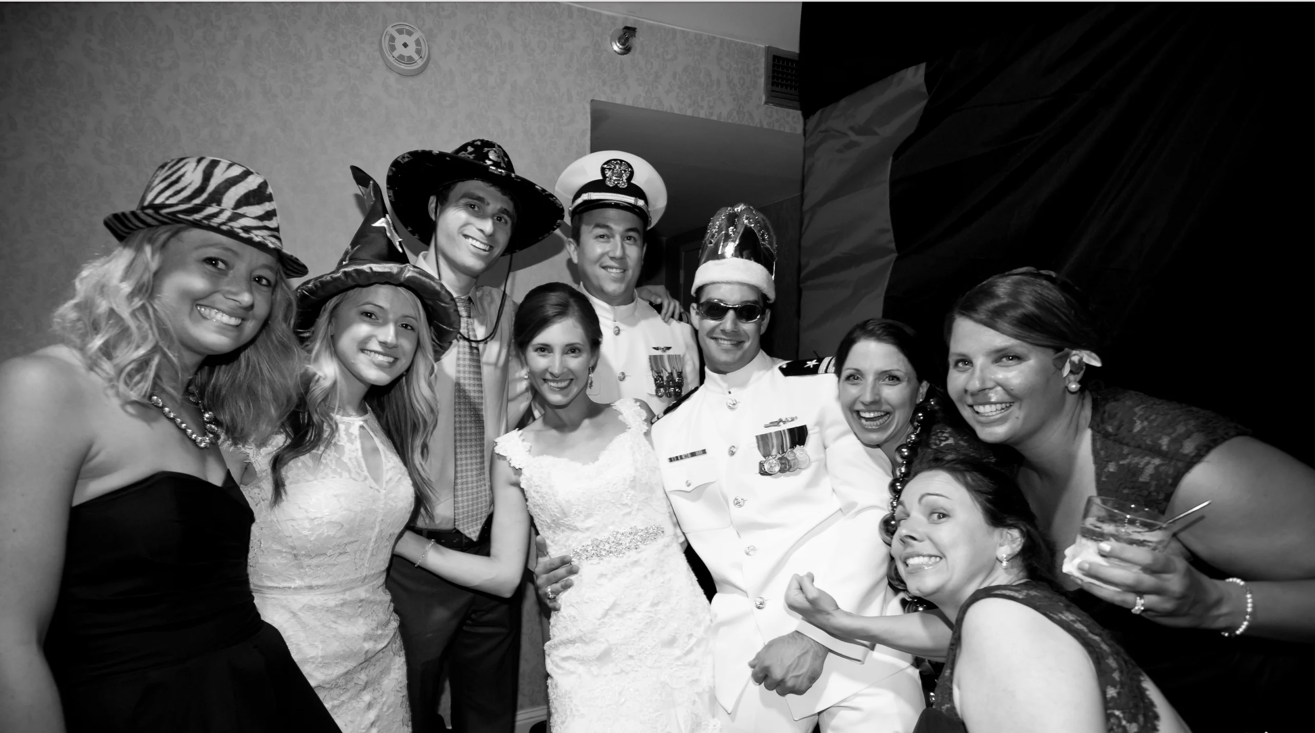 Group of people in formal and themed attire posing together at an event.