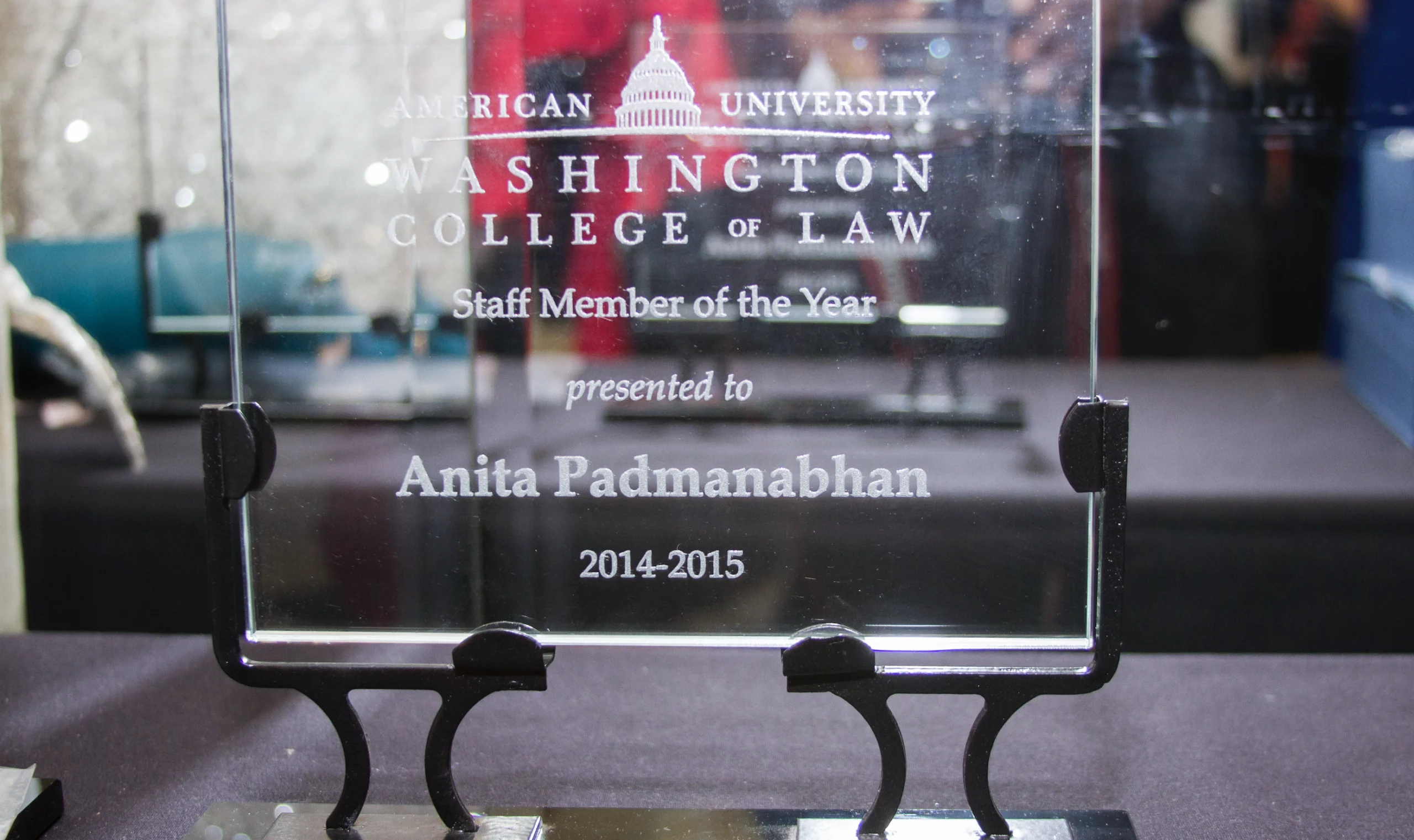A glass plaque awarded to Anita Padmanabhan for being Staff Member of the Year 2014-2015 by American University's Washington College of Law.